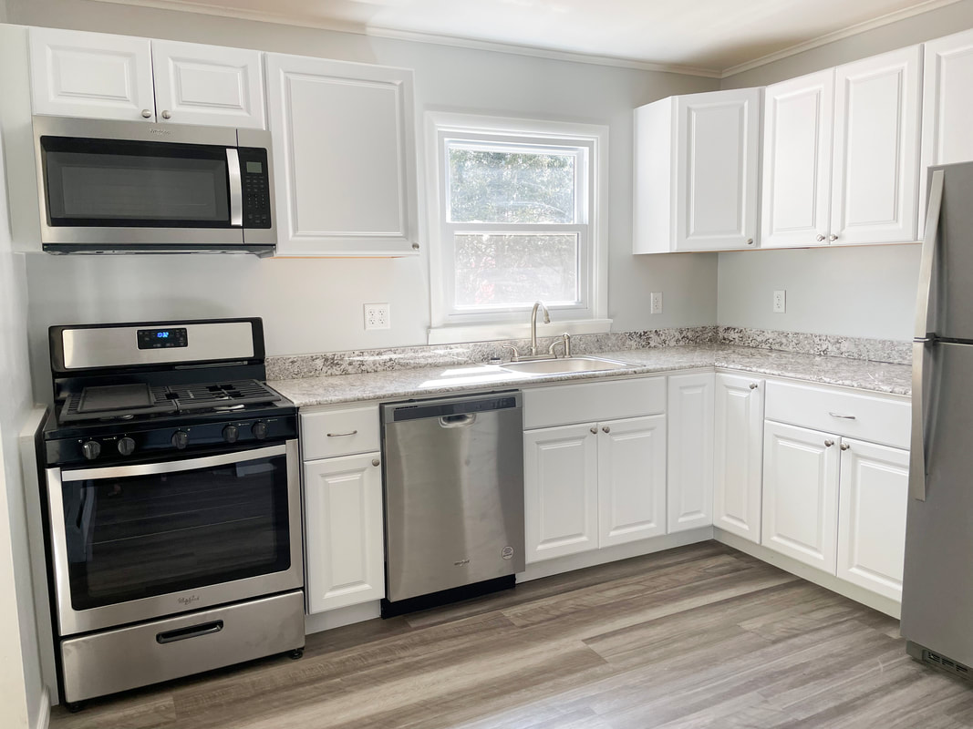 Renovated kitchen with stainless appliances and granite counters
