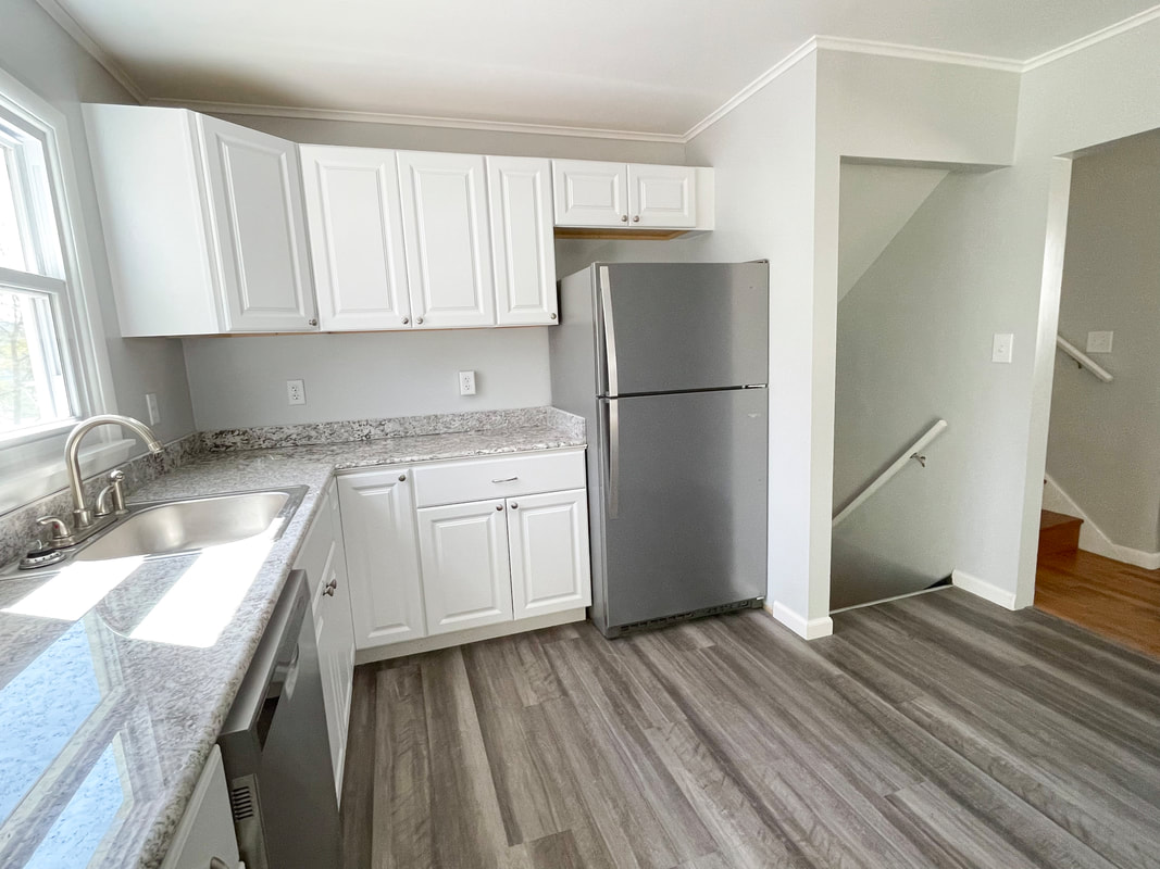Kitchen view with refrigerator and stairs